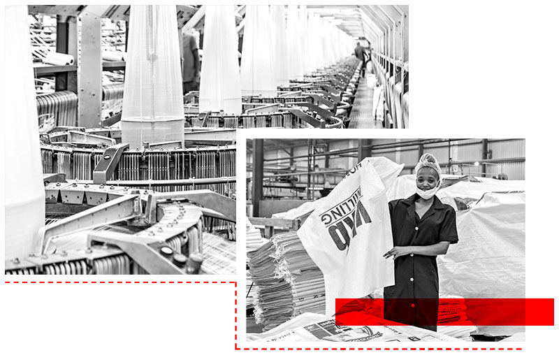 Factory worker handling rolls of polywoven material in manufacturing facility