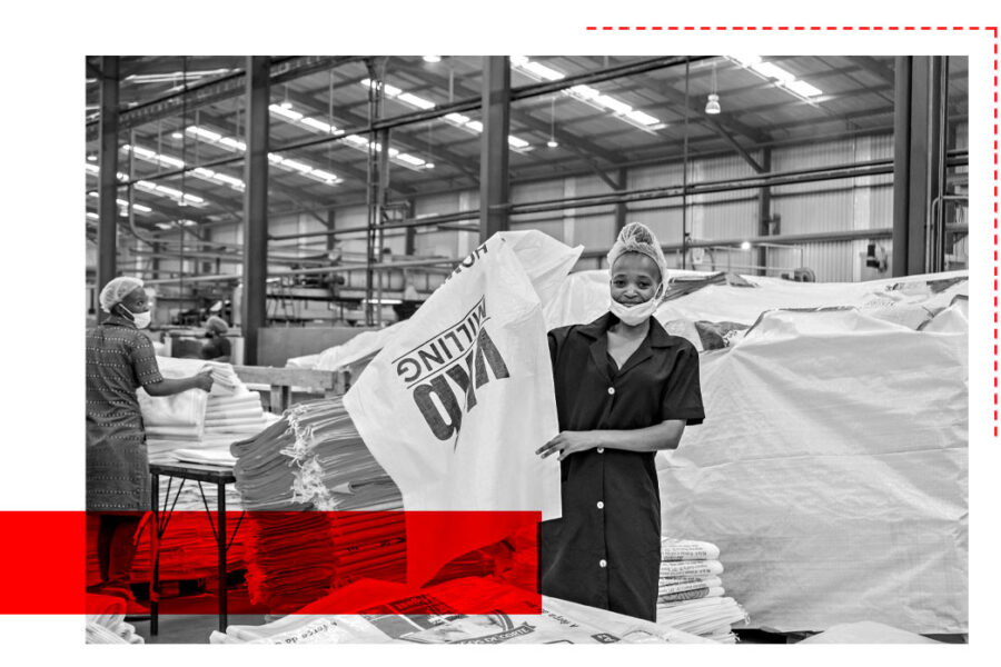 Factory worker overseeing polywoven bag production with hands-on service at Wang On Fibres