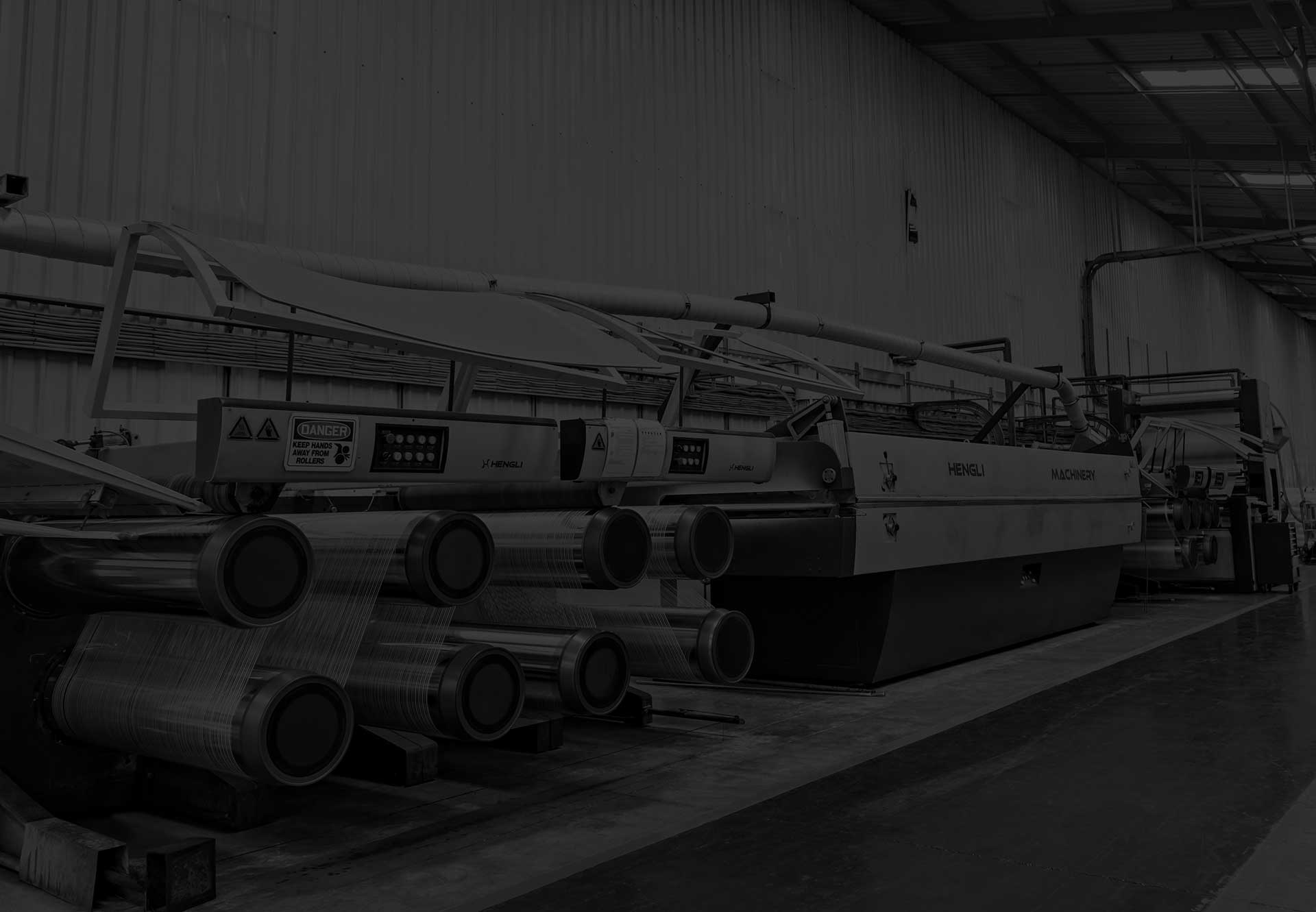 Industrial factory background showcasing polywoven bag manufacturing at Wang On Fibres