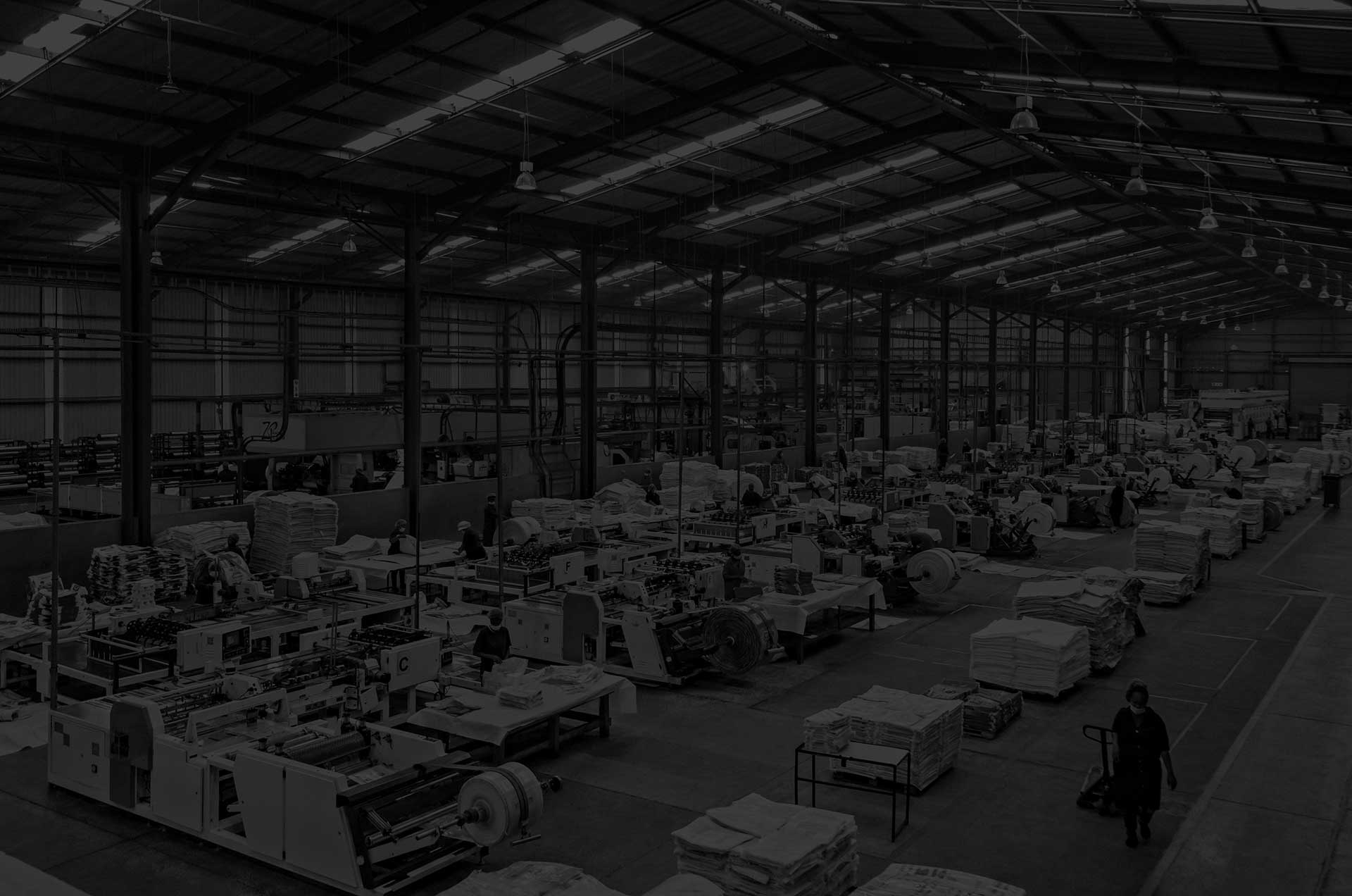 Industrial factory background showcasing polywoven bag manufacturing at Wang On Fibres